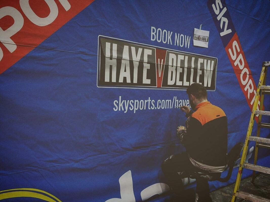 Signwriting a advert for bellew v haye on a boxing canvas 