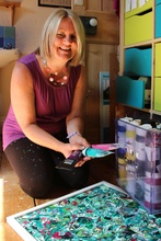 Worcester artist Cherrie Mansfield in her studio holding tubes of paint