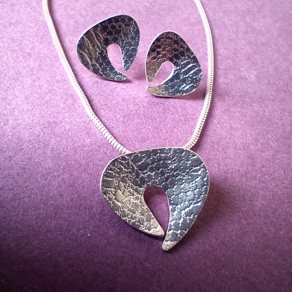 Textured silver shell form earrings and pendant