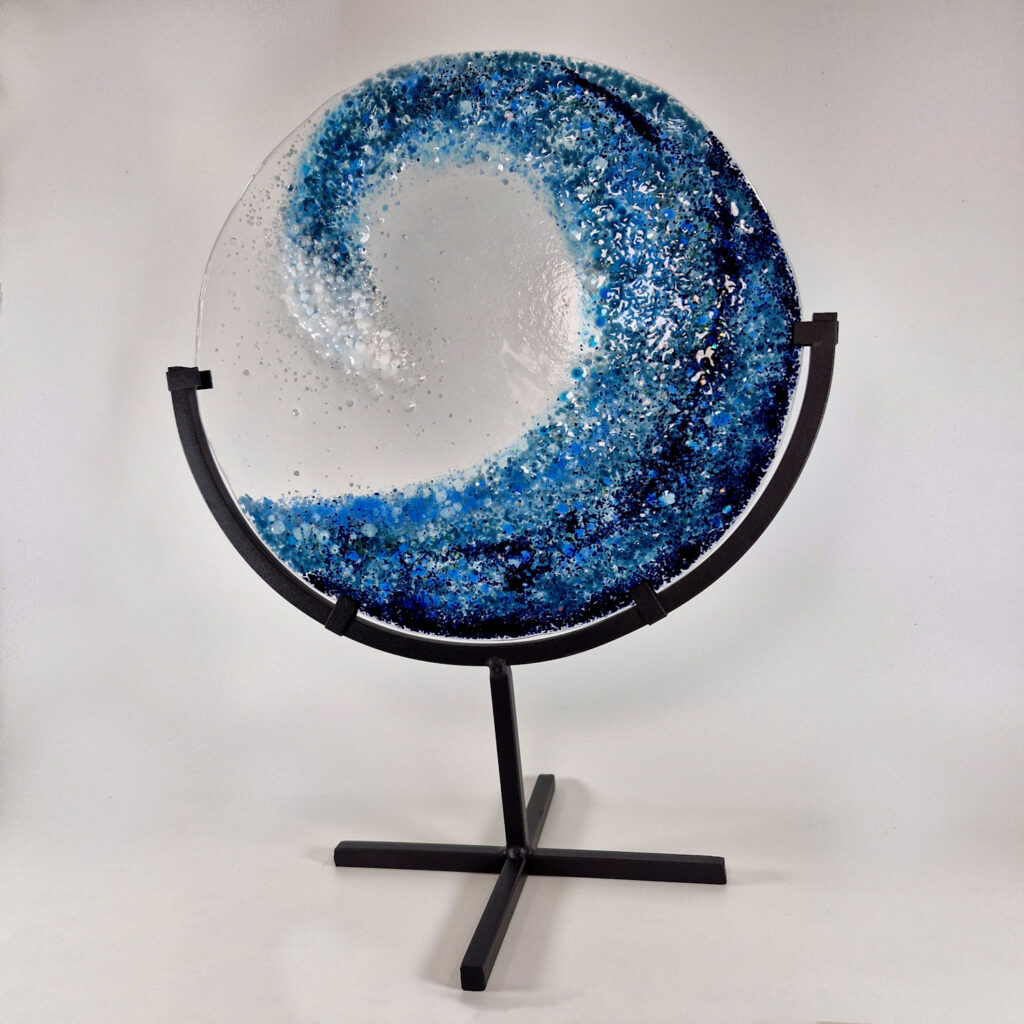 Fused glass wave mounted on a metal stand