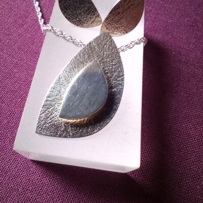 Belinda Gilbert - Textured and polished silver earrings and pendant