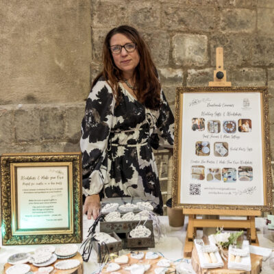 Katie Beasley - Art Clay Love - Katie at her stall at at wedding fayre, showcasing ceramic wedding favours, place settings and workshops for bridal parties.