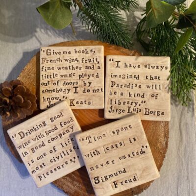 Katie Beasley - Art Clay Love - Four ceramic coasters with different hand stamped quotes that reference literary figures or books.