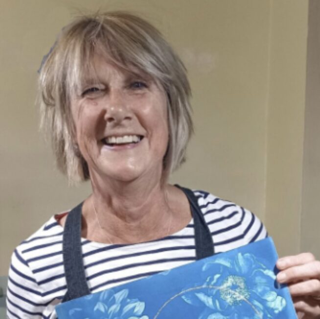 portrait of artist with artwork