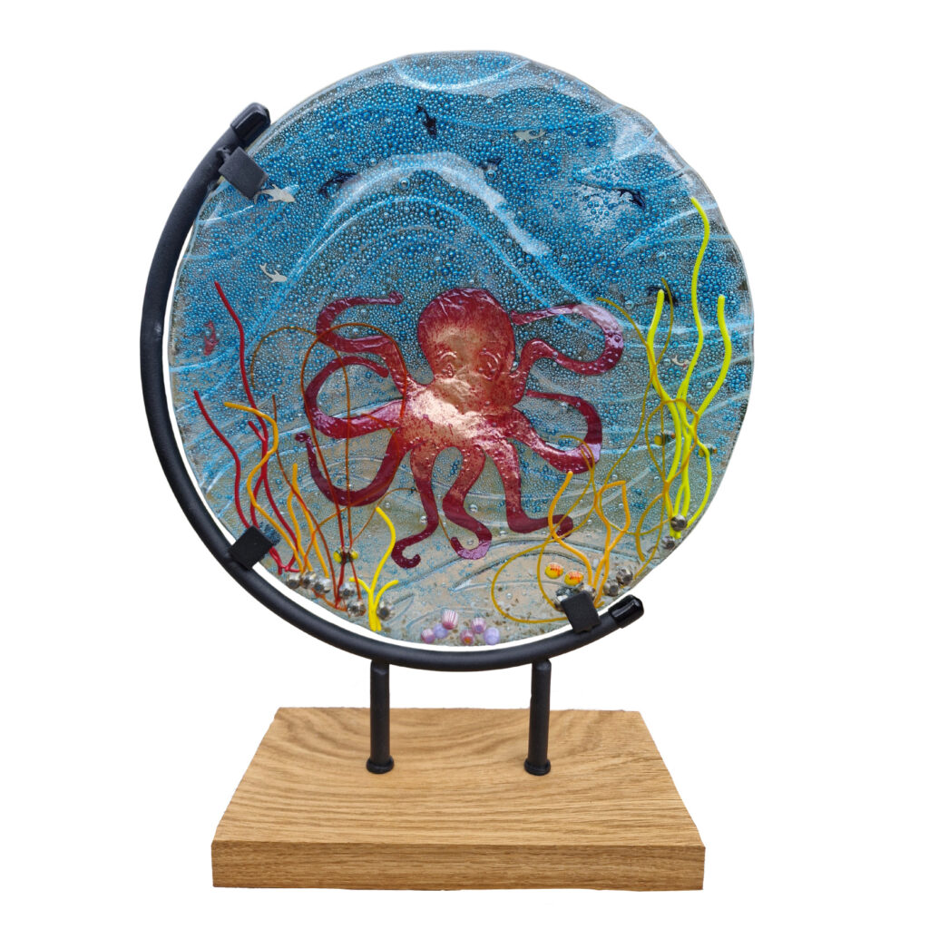 Hand cut copper octopus embedded in kiln carved glass
